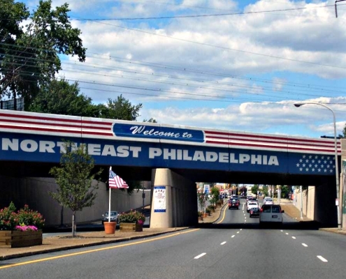 Patriotic bridge with the words Welcome to Northeast Philadelphia on it, the welcoming to Bustleton PA we buy house Bustleton PA