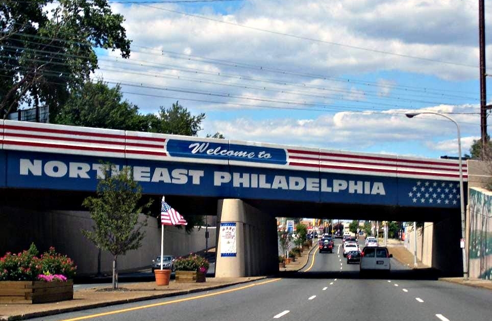 Patriotic bridge with the words Welcome to Northeast Philadelphia on it, the welcoming to Bustleton PA we buy house Bustleton PA