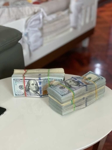 Stacks of money on table. When selling a home for cash in Philadelphia you can get paid right away