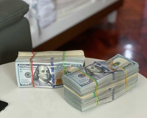 Stacks of money on table. When selling a Philly home for cash you can get paid right away